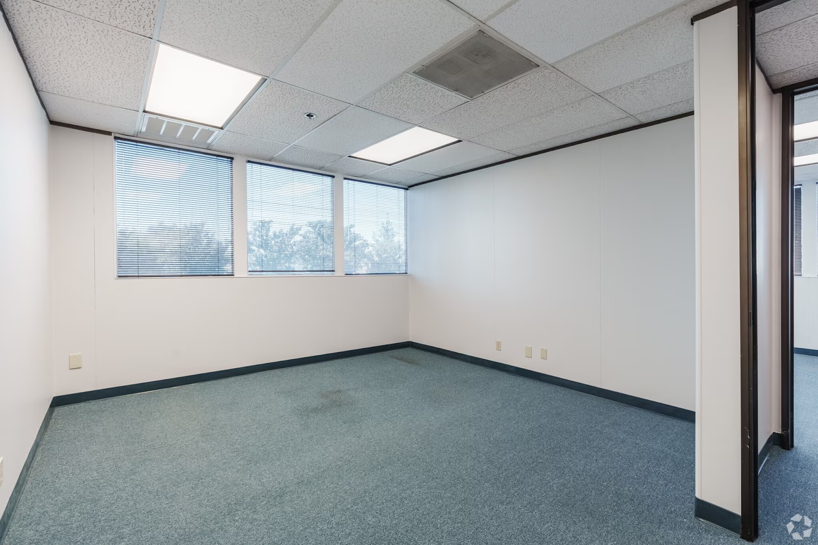 Private 300 SF office suite for lease at 200 New Stine Building in Bakersfield CA featuring large windows and natural light.